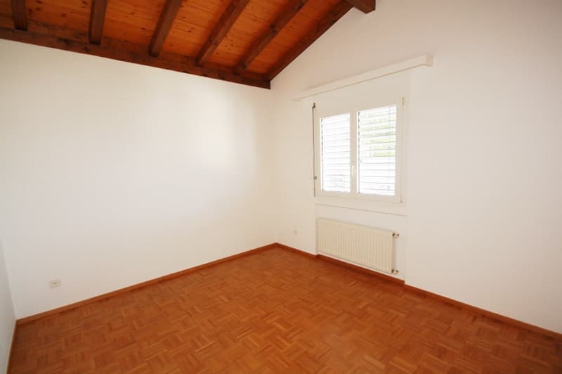 wooden floor, wooden ceiling, radiator, white wall, window