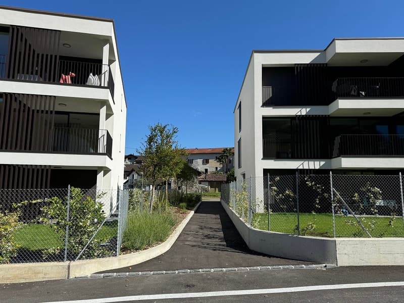 Modern design white buildings with balconies, modern design, grass, pavements, fencing