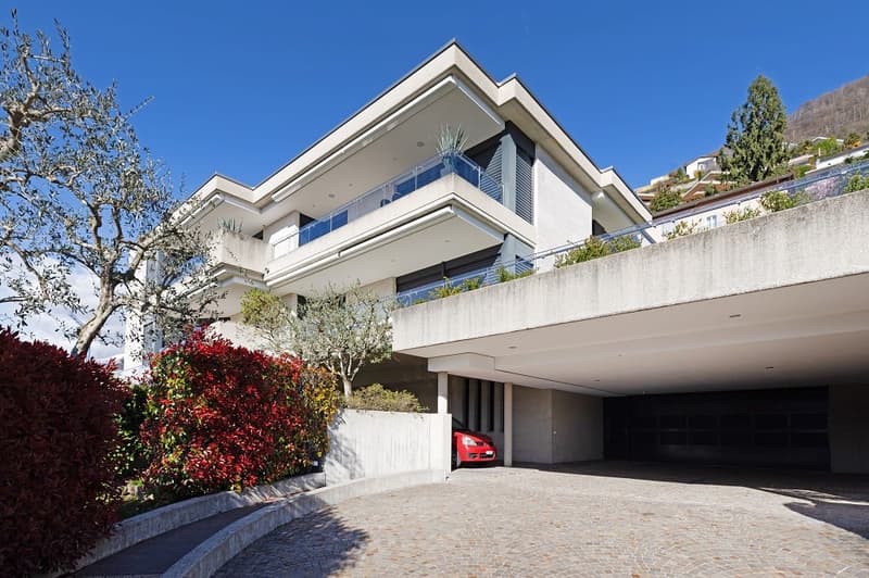 Modern white house, 3 stories, balcony, garage, red car parked