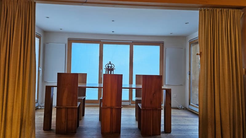 Wooden table, wooden chairs, floor, bright daylight, glass doors