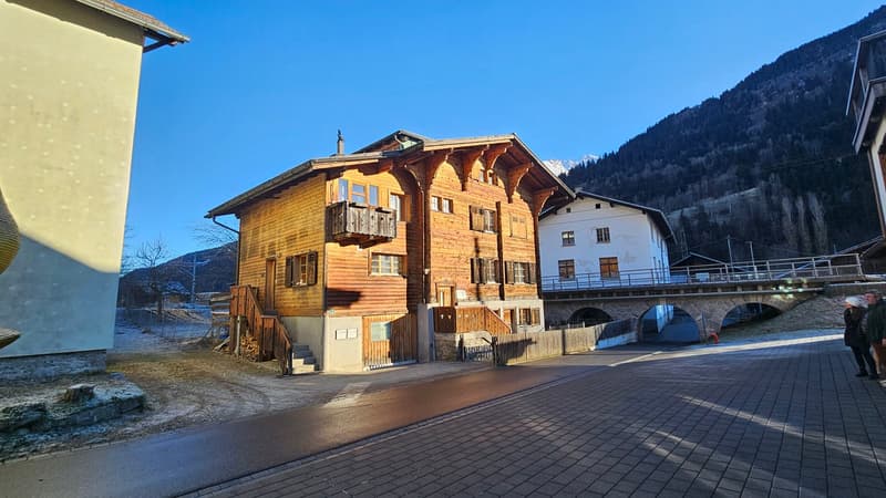 Wooden house, sloped roof, wooden balcony, wooden door and steps, raised ground floor