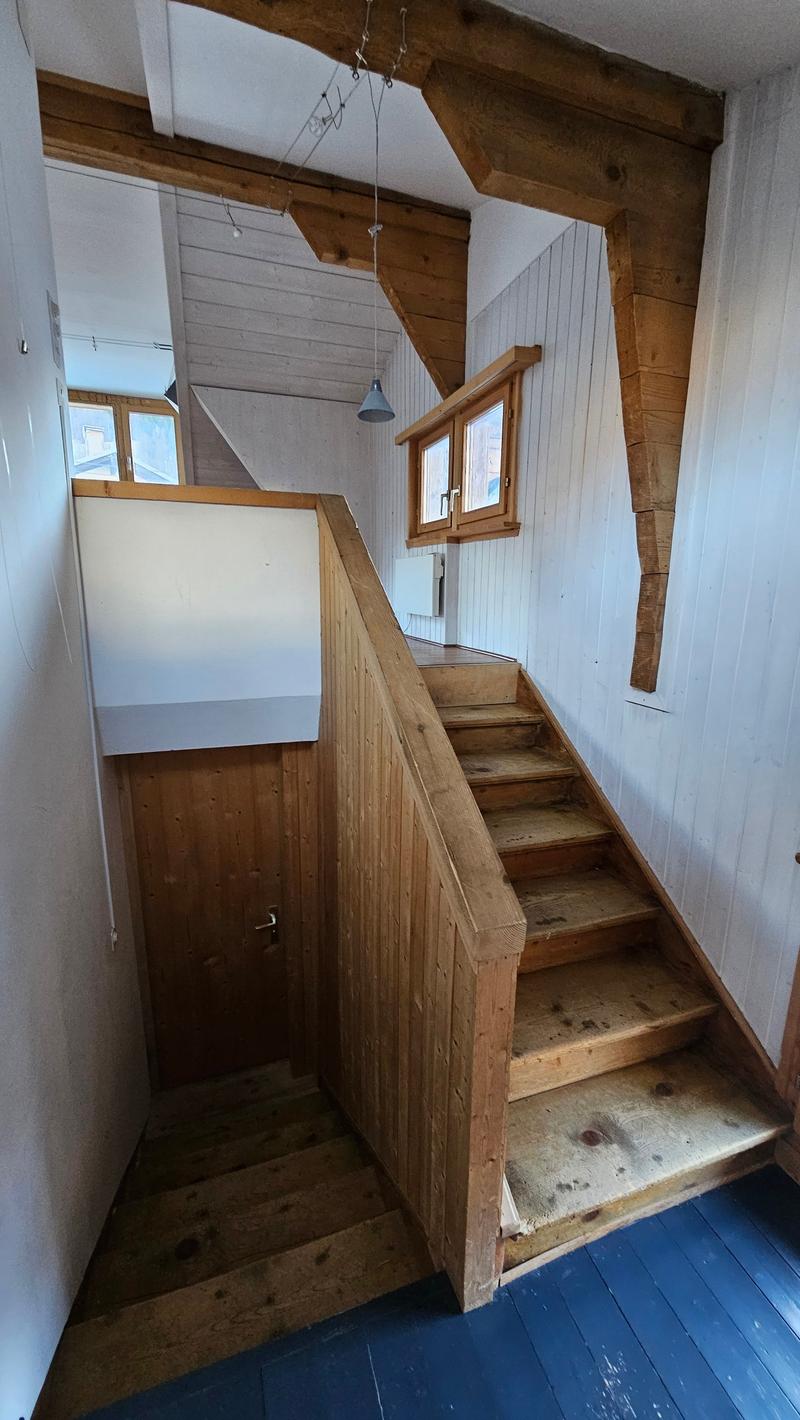wooden staircase, wooden paneling, windows with wooden frames