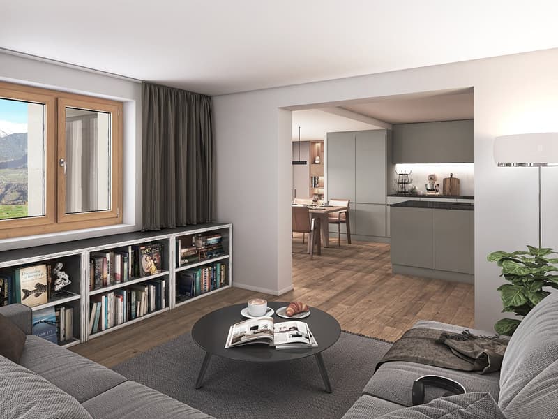 Open plan living room and kitchen with books, coffee table, couch, and view to the mountain