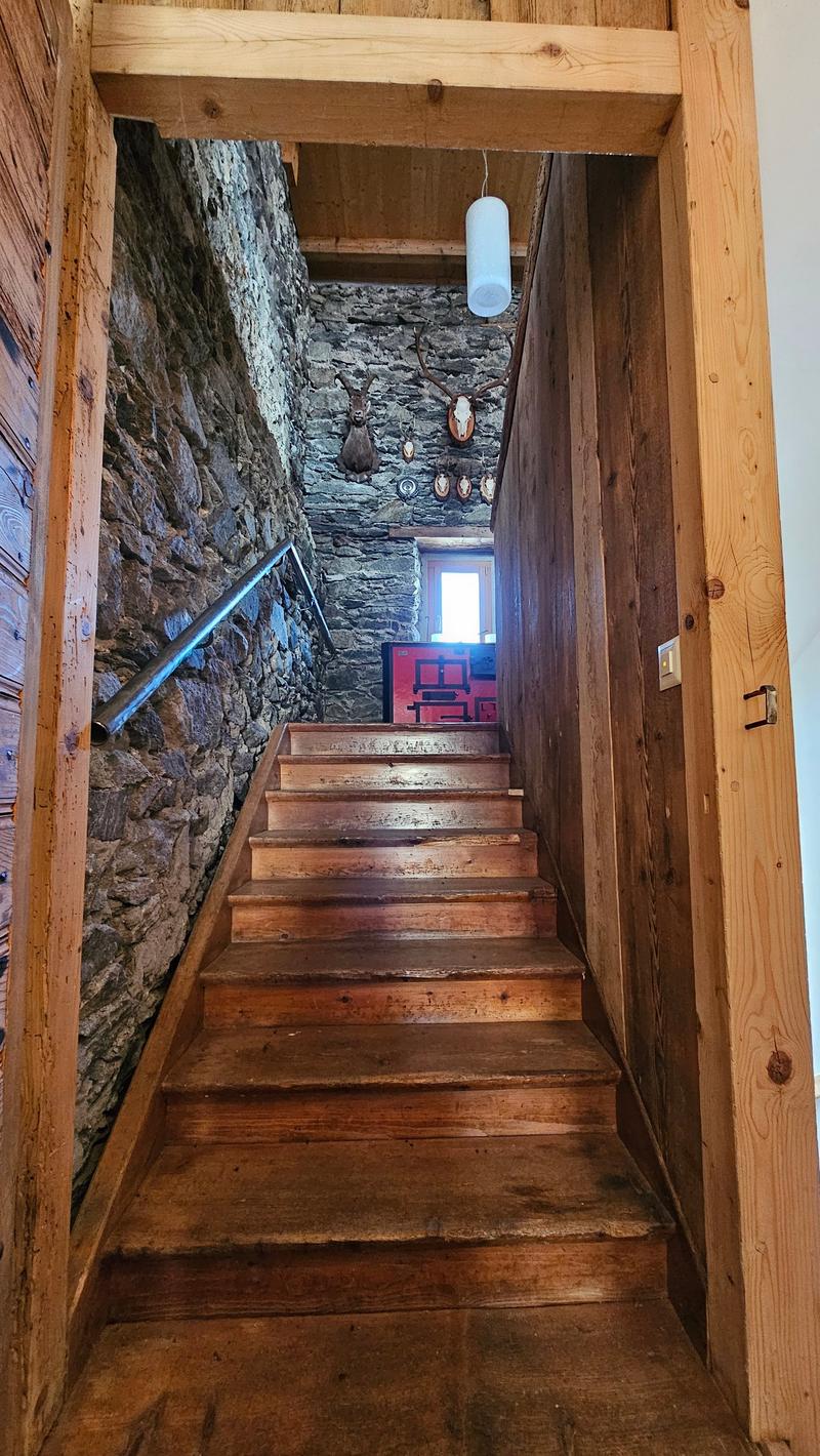 interior stairs, wooden steps, stone wall, handrail, stone wall