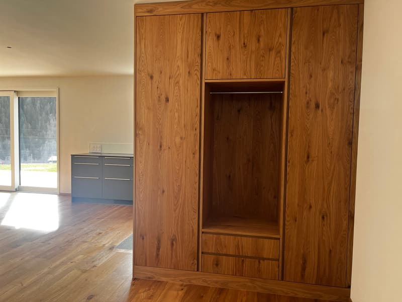 wooden closet, wooden floor, glass sliding doors, gray counter