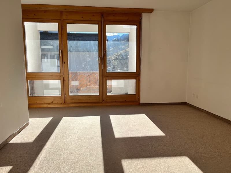 empty room, large glass doors, balcony, carpeted floor, white walls, power outlets