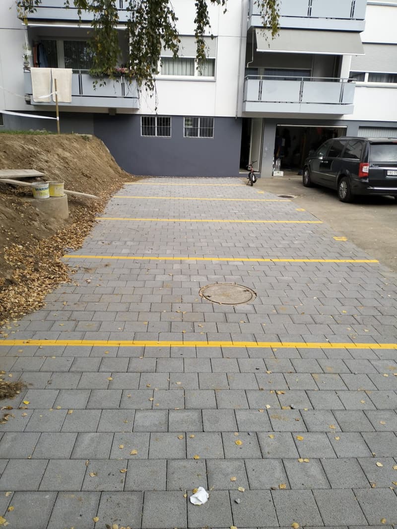 a paved parking lot with several parking spots