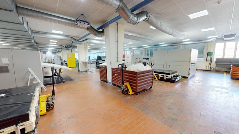industrial warehouse with orange tiled floor, heavy duty carts, industrial racks and containers