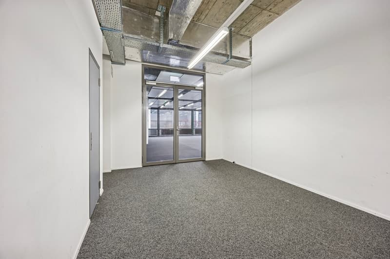 empty room with sliding door and windows