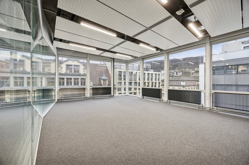 large glass windows, modern design, carpeted floor, large open space