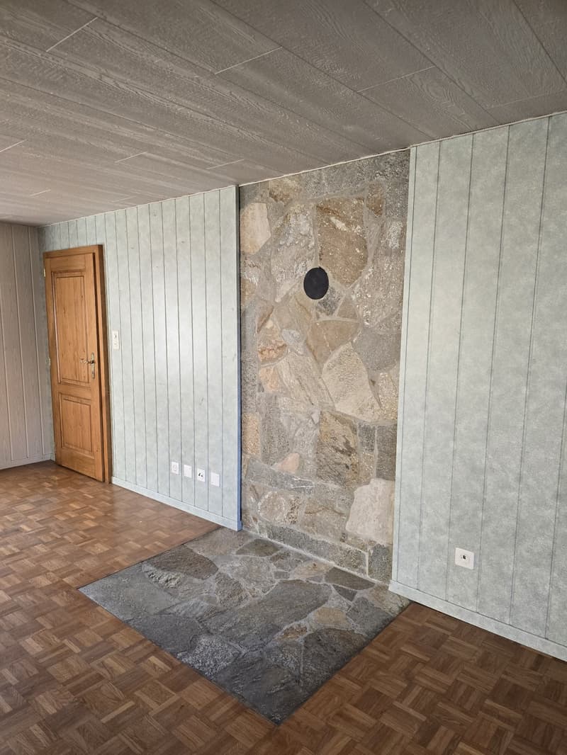 wooden door, grey stone wall, grey stone flooring, wooden floor, power outlets