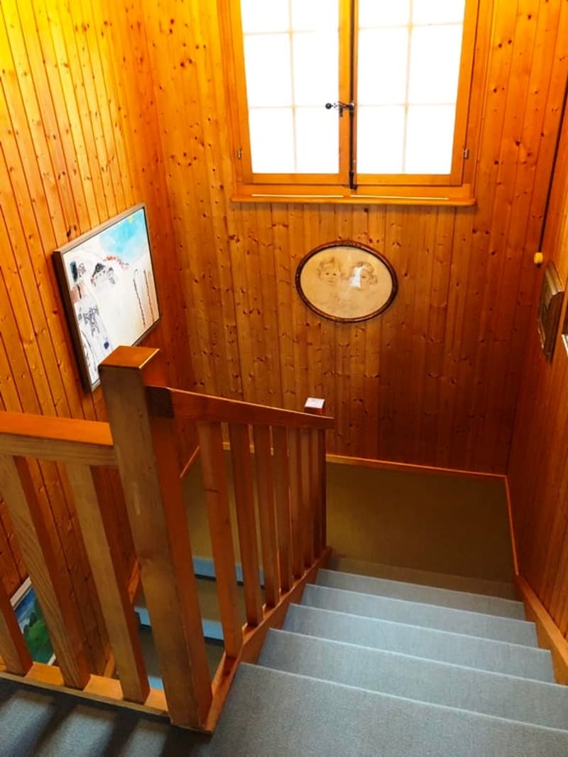 wood paneled walls, staircase, windows, framed artwork