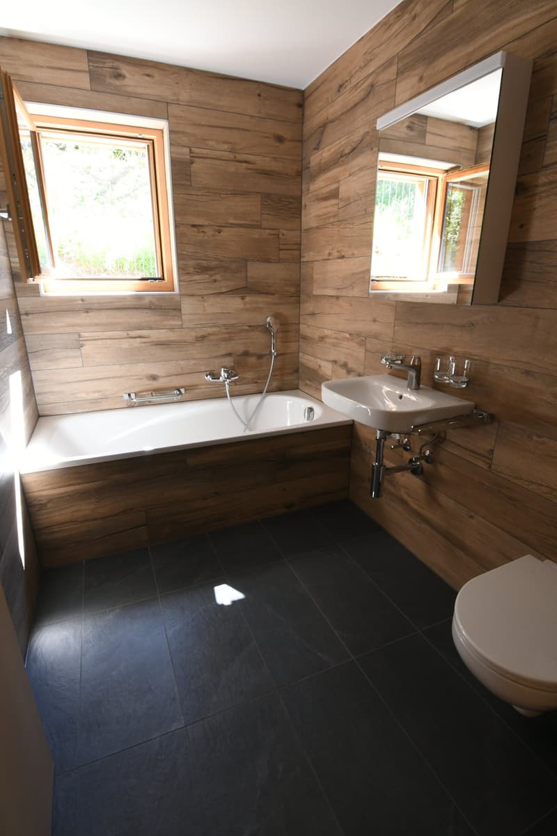 wooden walls, bathtub, sink, toilet, windows