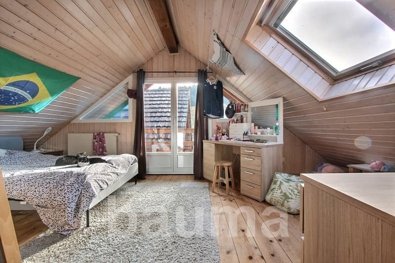 wooden ceiling, wooden floor, bed, carpet, desk, stool, lamp, flag, cat