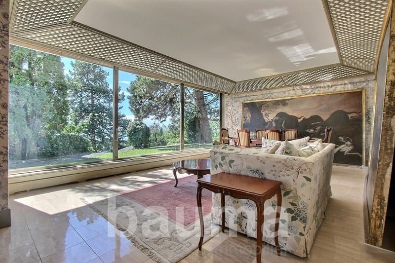large windows, floral sofa, wooden table, large painting, carpet, tiled floor