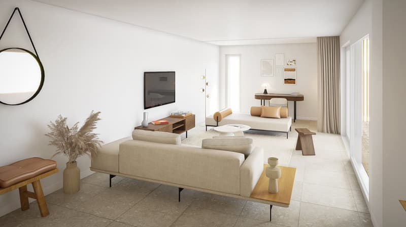Spacious living room with white walls, large windows, beige sofa, wooden TV stand, coffee table, and decorative accents. The room has a minimalist and modern design aesthetic.
