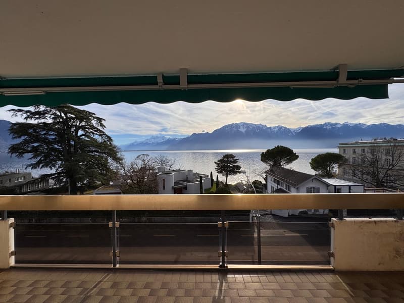 view of lake and mountains, large balcony, glass railing, tiled floor