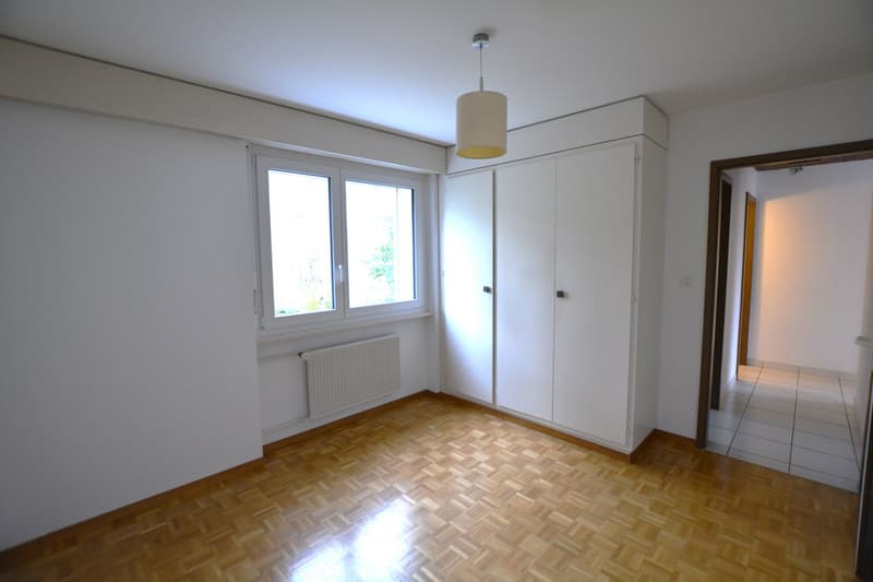 empty room, white walls, wooden floor, double window, white wardrobe, pendant light