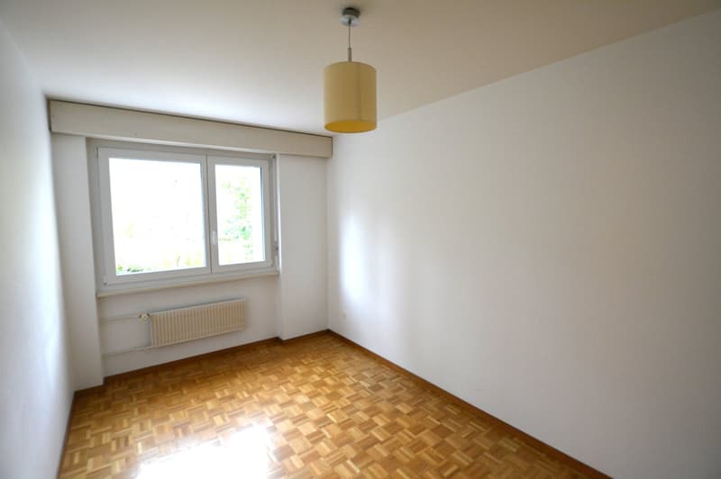 empty room, wooden parquet floor, window, white walls, radiator
