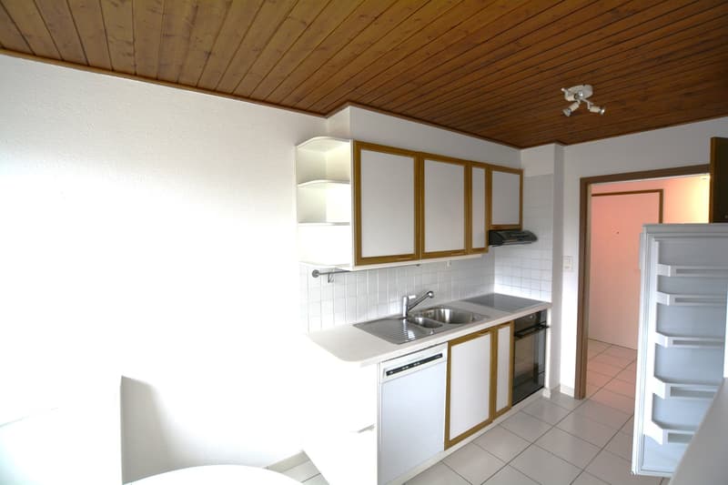 modern kitchen with white appliances, tiled floor, cabinets, sink, gas stove