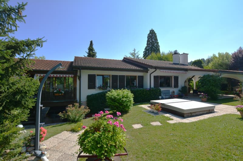 Two story house, brown roof, white walls, garden, covered porch, pool, plants, trees