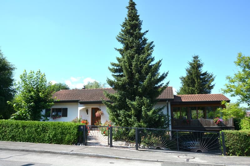 Single-family house, brown roof, white walls, garden, balcony, car under the covered area