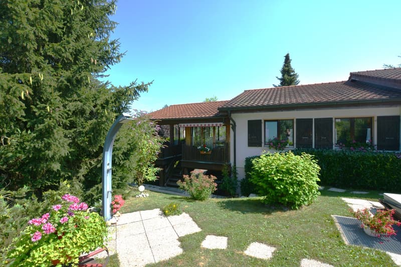2 story house, brown roof, white walls, covered porch, glass windows, balcony, wooden stairs, garden, fireplace
