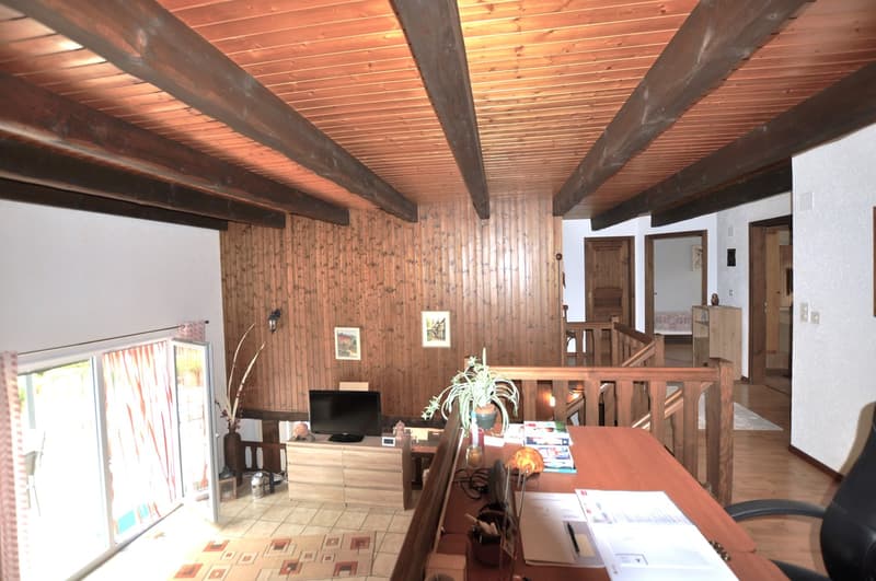 living room, wooden walls, wooden desk, sliding glass door, television, wooden stairs