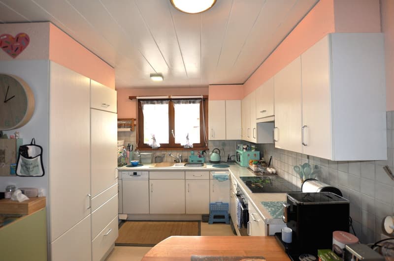modern kitchen with white cabinets, tile flooring, sink, dishwasher, clock, shelves, microwave, gas stove, fridge, utensils