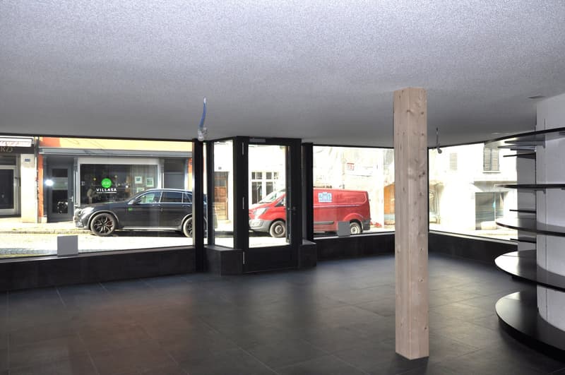 Empty room with large windows, tiled floor, wooden column, no furniture