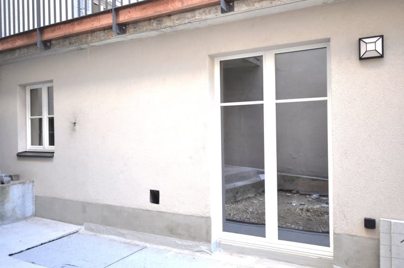 elevated ground floor, double glazed doors, glass windows, stucco wall