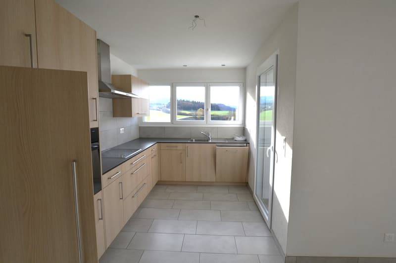 Modern kitchen with wooden cabinets, granite countertops, double sink, stainless steel faucet, kitchen appliances (oven, stove), double windows, tiled floor, and scenic view.