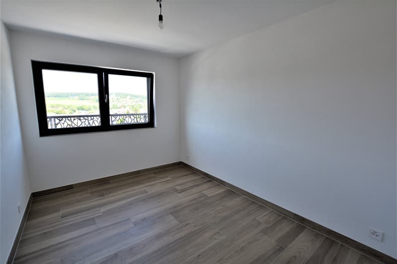 Empty room, window, tiled floor, light fixture, electrical outlet.
