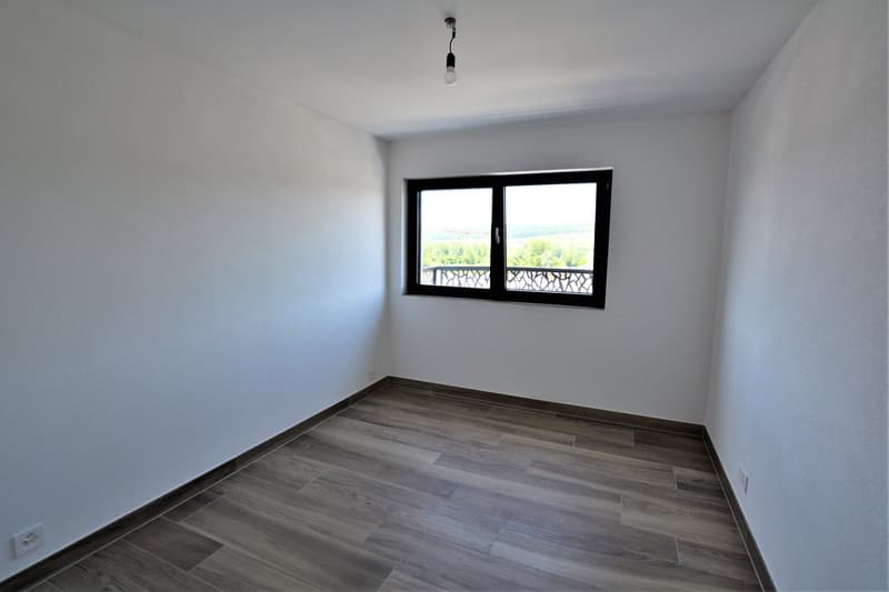 modern, empty room, white walls, balcony with railings, wooden floor, window, electrical outlets