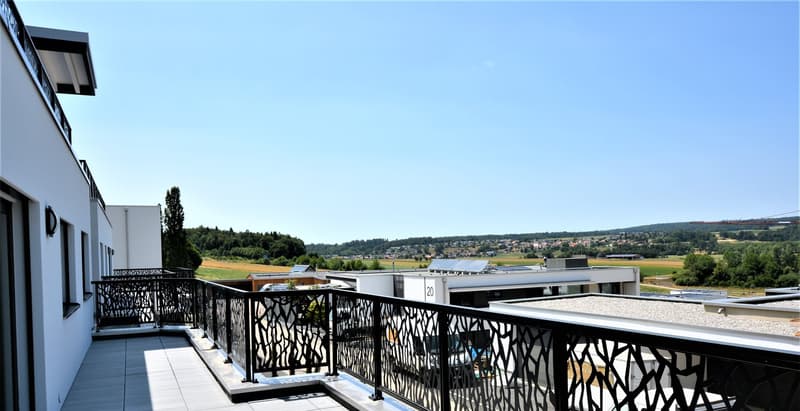 Terrace with tiled floor and black metal railing, expansive countryside view