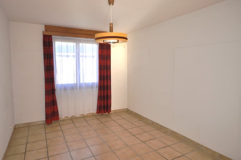 empty room with white walls, tile flooring, pendant lamp, red curtain, white curtain, window