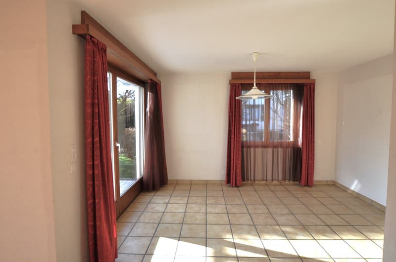 empty room with two glass doors, red curtains, light fixtures, tiled floor, white walls