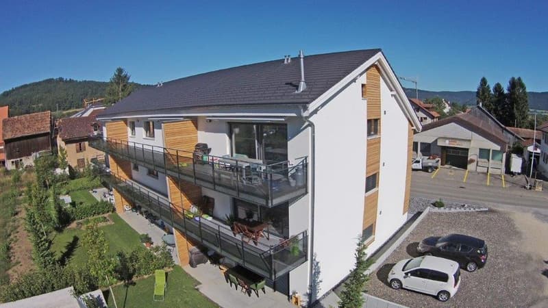 Apartment building, modern style, 3 floors, balconies on the second and third floor, parking lot in front
