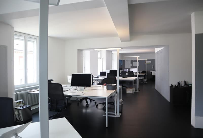 modern office space, desks, chairs, monitors, cabinets, radiators, windows