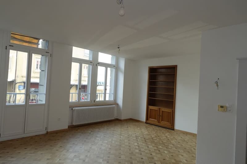 empty room, parquet floor, double doors, windows, radiator, wooden cabinet