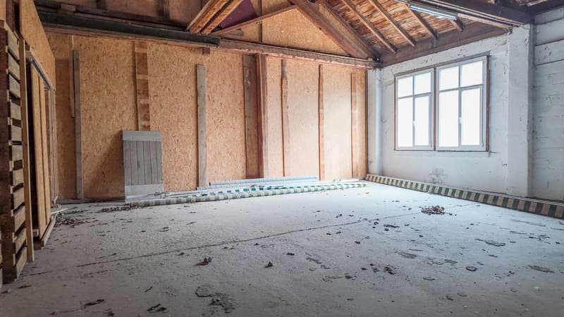 unfinished room, wooden beams, plaster wall, empty floor, window, storage box