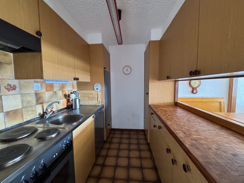 wooden cabinets, tiled backsplash, electric stove, stainless steel sink, dishwasher, countertop