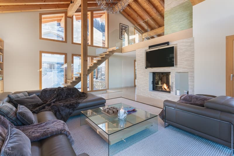 living room with open layout, glass window, fireplace, staircase, glass door, chandelier