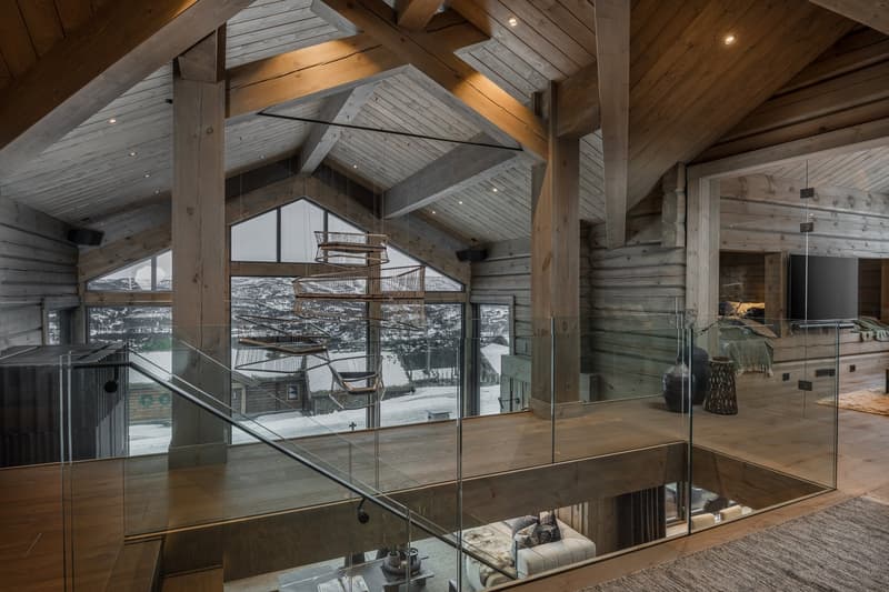 loft style interior, wooden beams, glass walls and floor, fireplace