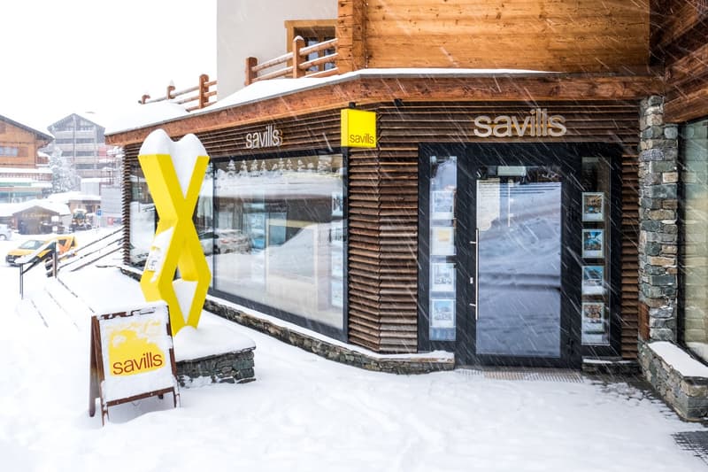 Wooden exterior, glass windows, signboard, snow-covered ground