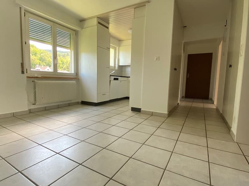 tiled floor, white walls, large window, white radiator, white cabinet, kitchen with dishwasher