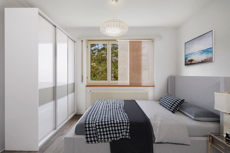 Spacious bedroom with large windows, white walls, hardwood floors, sliding wardrobe closets, a crystal chandelier, and a view of the outdoor greenery. The room is furnished with a king-size bed, nightstands, and a framed artwork on the wall.