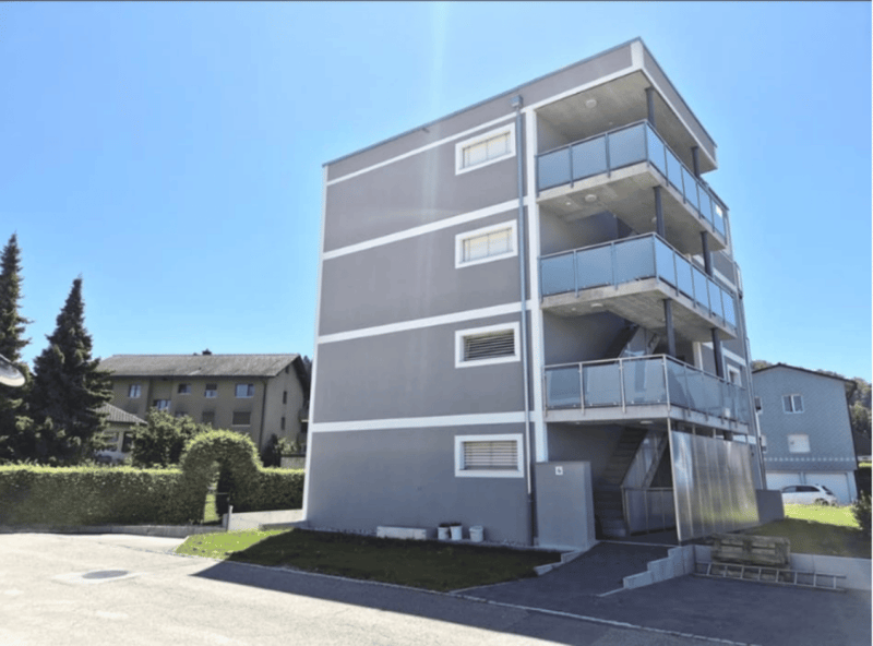 grey apartment building, balconies, parking lot, entrance