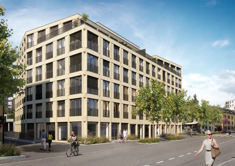 Modern multi-story building with beige exterior, large windows, and balconies on each floor