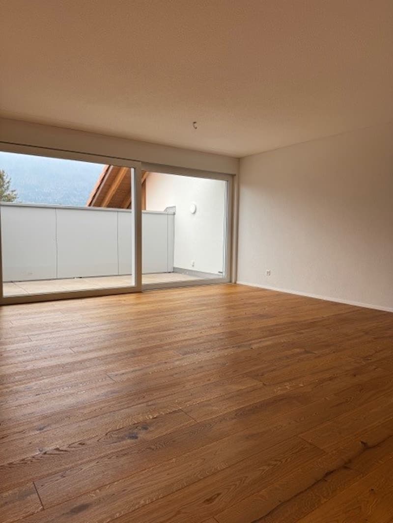 wooden floor, white walls, sliding doors, balcony